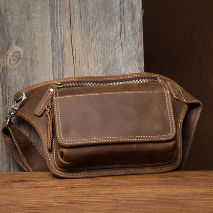 This vintage fashion leather waist bag from 2023 is a genuine leather sling bag designed for men. It serves as a chest bag, waist pack, or sling bag, offering both style and functionality