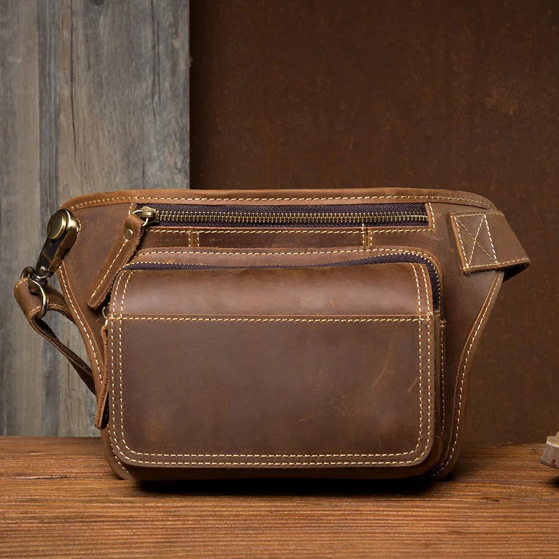 This vintage fashion leather waist bag from 2023 is a genuine leather sling bag designed for men. It serves as a chest bag, waist pack, or sling bag, offering both style and functionality