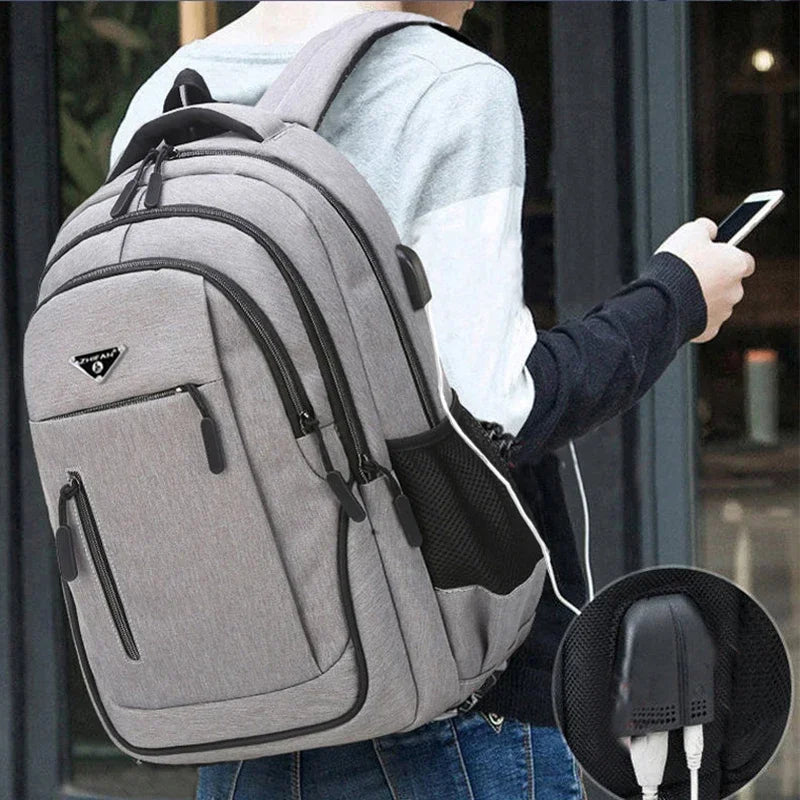 This large capacity backpack is designed for men, featuring a solid black Oxford fabric. Suitable for high school and college students, it accommodates laptops up to 15.6 inches.